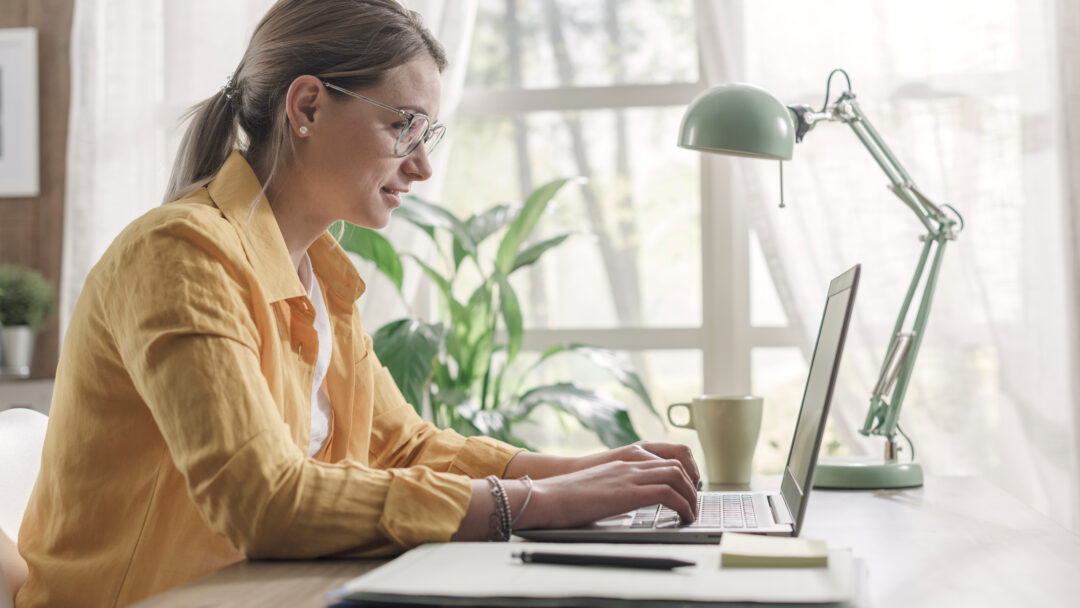 Young businesswoman sitting at desk and working from home