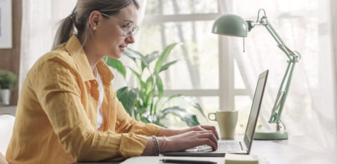 Young businesswoman sitting at desk and working from home