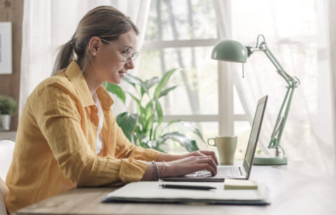 Young businesswoman sitting at desk and working from home