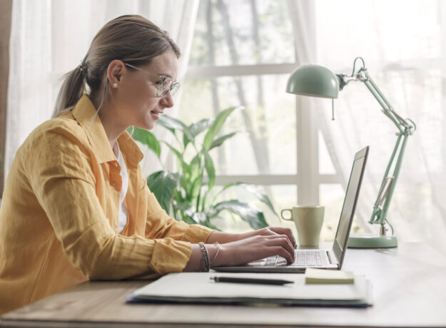 Young businesswoman sitting at desk and working from home