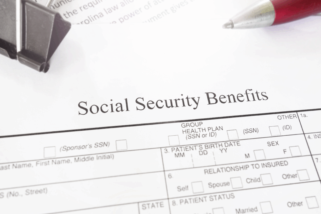 Social Security Benefits form on a desk with a red pen and paperclip.