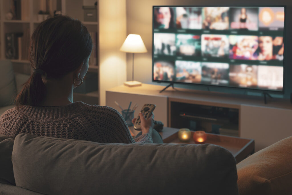 Woman looking at streaming options on tv