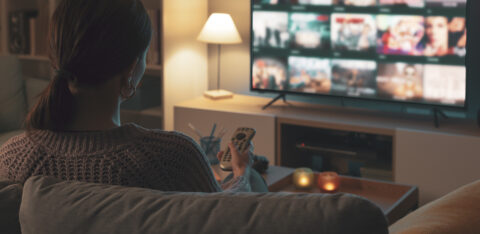 Woman looking at streaming options on tv
