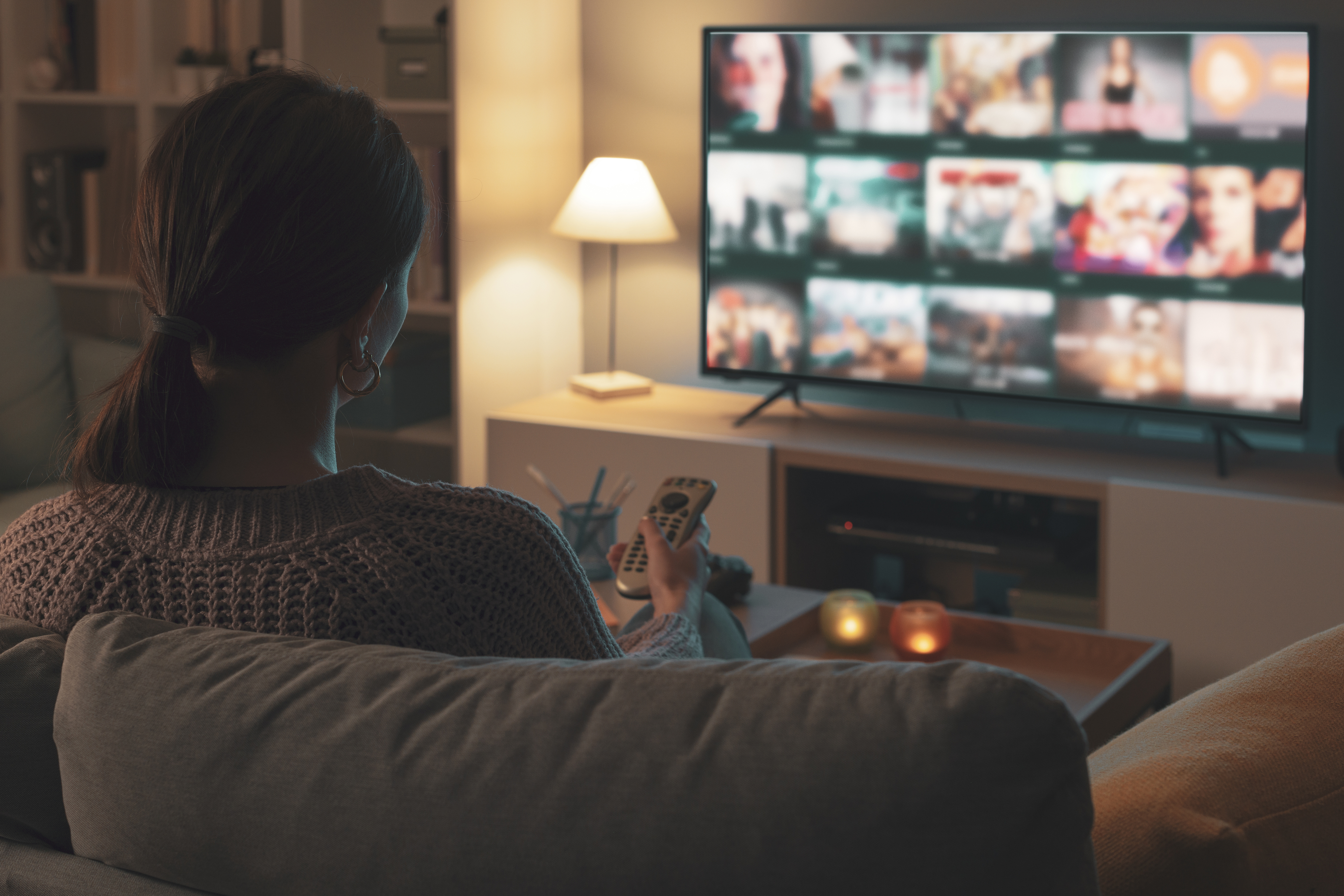 Woman looking at streaming options on tv