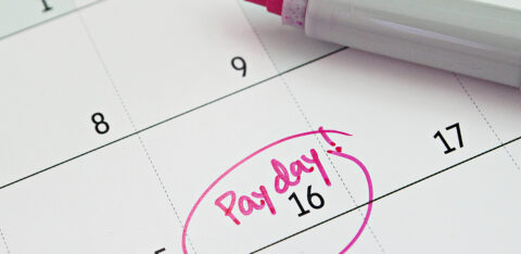 Close-up of a calendar showing the 16th marked as payday in pink marker.