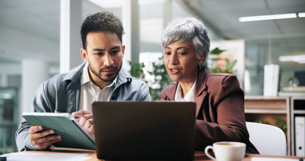Creative people, tablet and laptop in office for planning, fact check and help with editor feedback. Staff, team and advice with tech for research, article comparison and information for publication