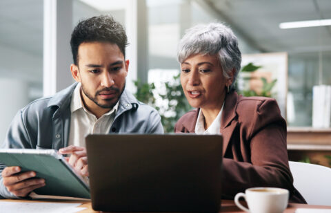 Creative people, tablet and laptop in office for planning, fact check and help with editor feedback. Staff, team and advice with tech for research, article comparison and information for publication