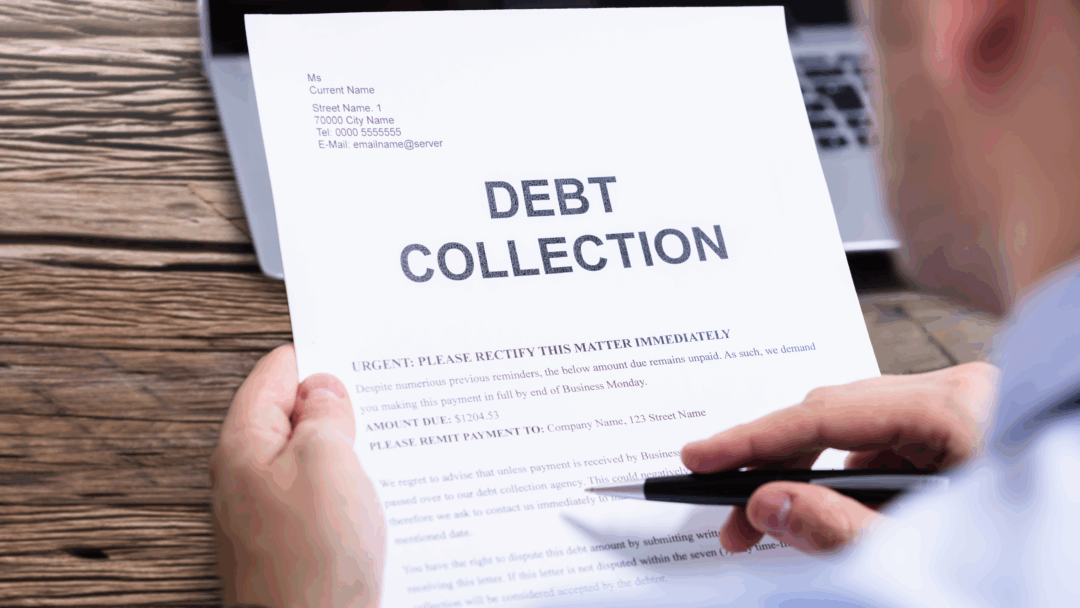 Person holding a debt collection notice with the words “Debt Collection” printed in large letters at the top.