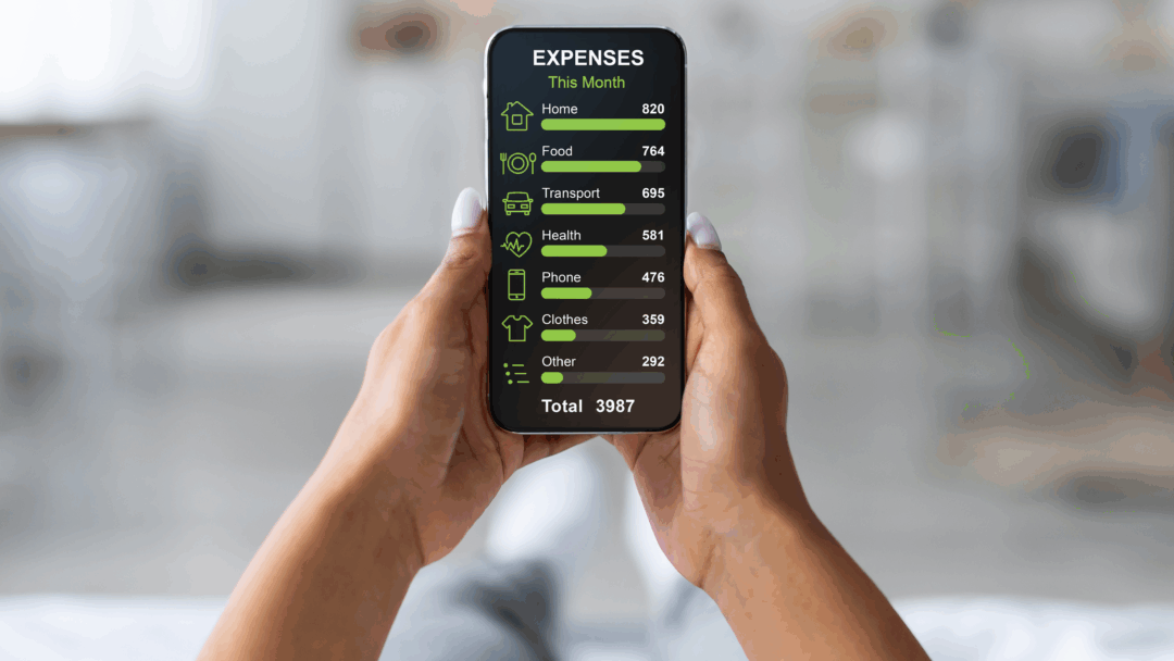 Person holding a smartphone that displays a monthly expense breakdown, including housing, food, transportation, health, phone, clothing, and other costs.