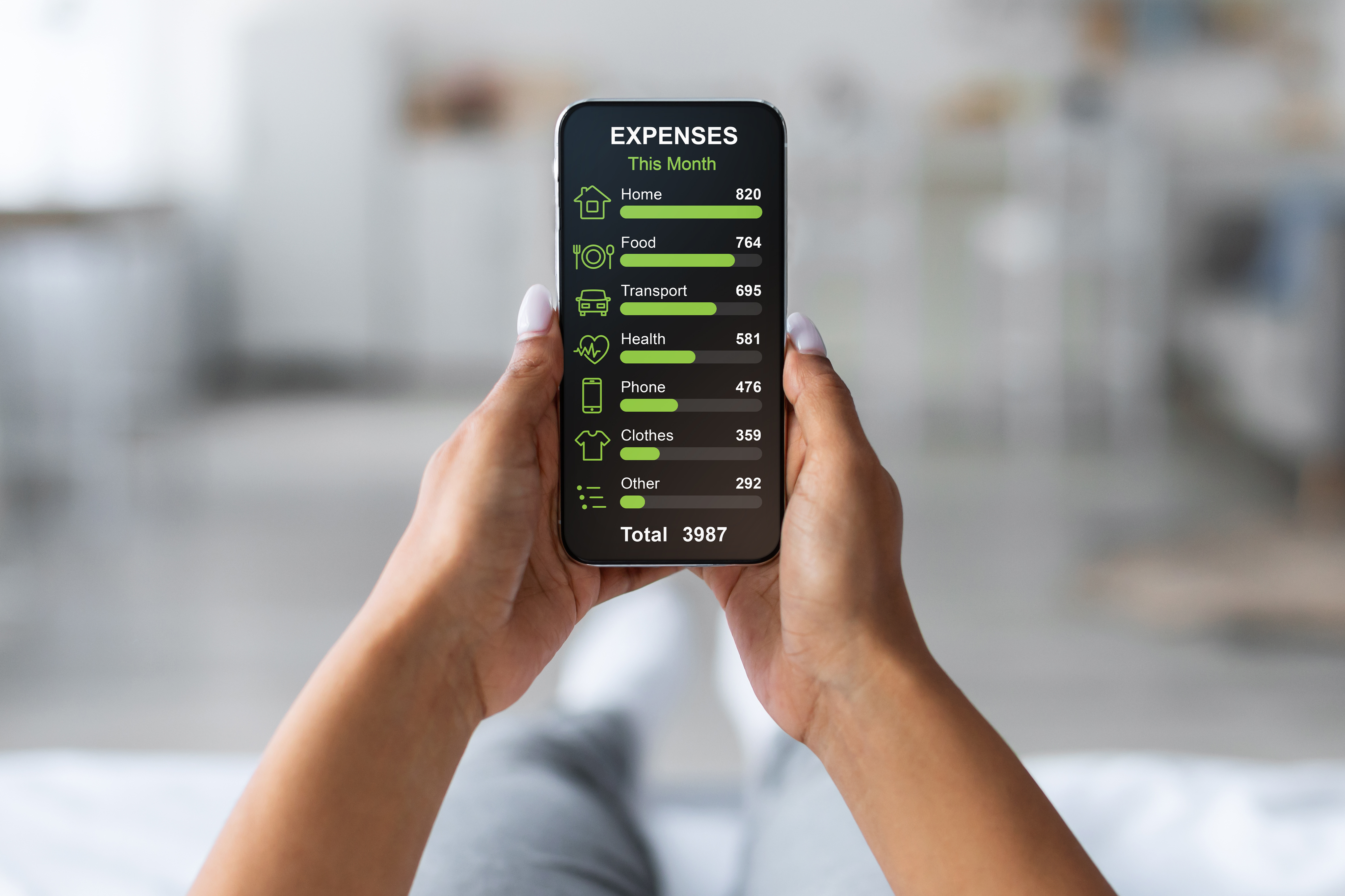 Person holding a smartphone that displays a monthly expense breakdown, including housing, food, transportation, health, phone, clothing, and other costs.