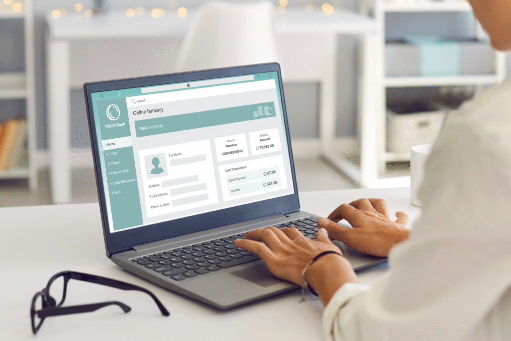 Person using a laptop to access an online banking account dashboard.