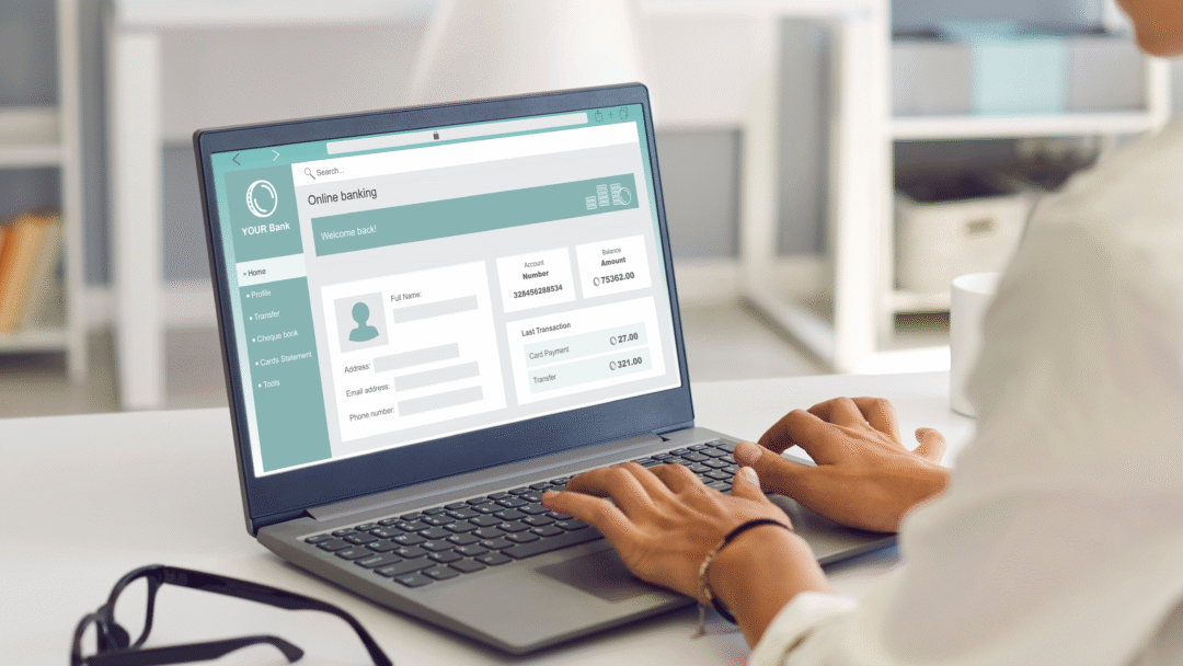 Person using a laptop to access an online banking account dashboard.