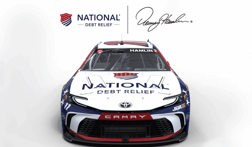 Front view of a National Debt Relief–branded NASCAR race car with red, white, and blue design elements.