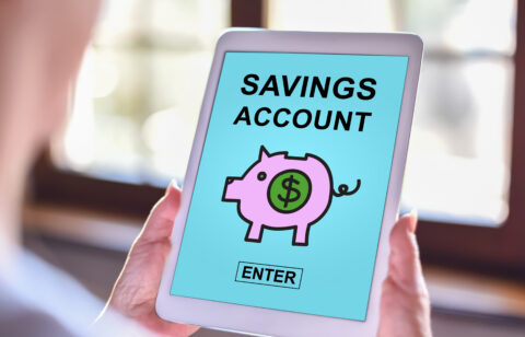 Tablet screen displaying “Savings Account” with a piggy bank icon and enter button.