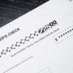 Close-up of a cashier’s check showing a payment amount of $725 with the date printed.