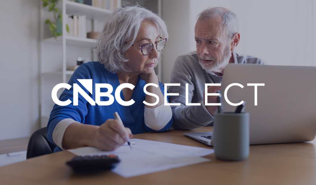 Older couple reviewing finances on a laptop with the CNBC Select logo overlaid on the image.