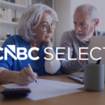 Older couple reviewing finances on a laptop with the CNBC Select logo overlaid on the image.