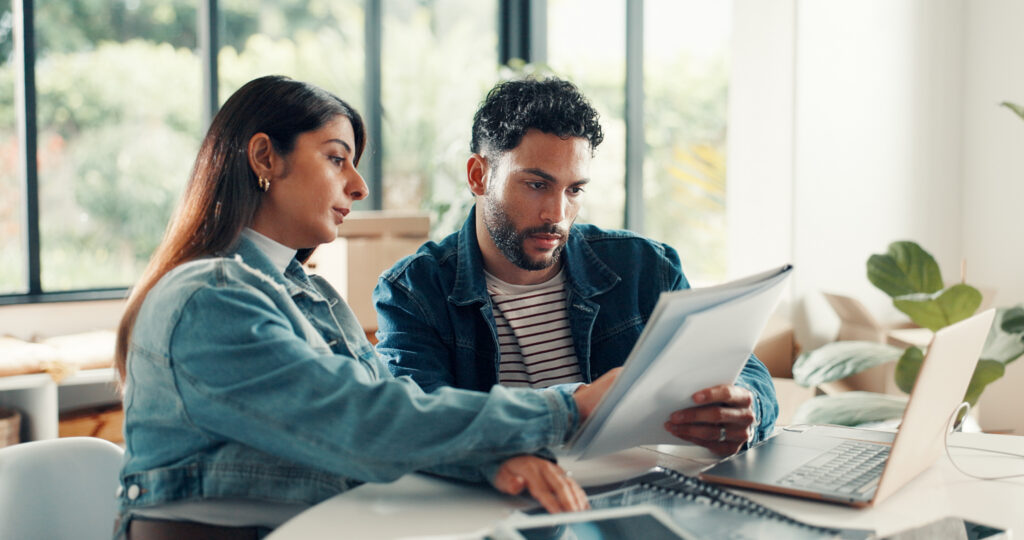 House, documents and couple with laptop, discussion and planning finance with savings. Assets, paperwork and man with woman, pc and expenses with budget, mortgage payment or bills with life insurance