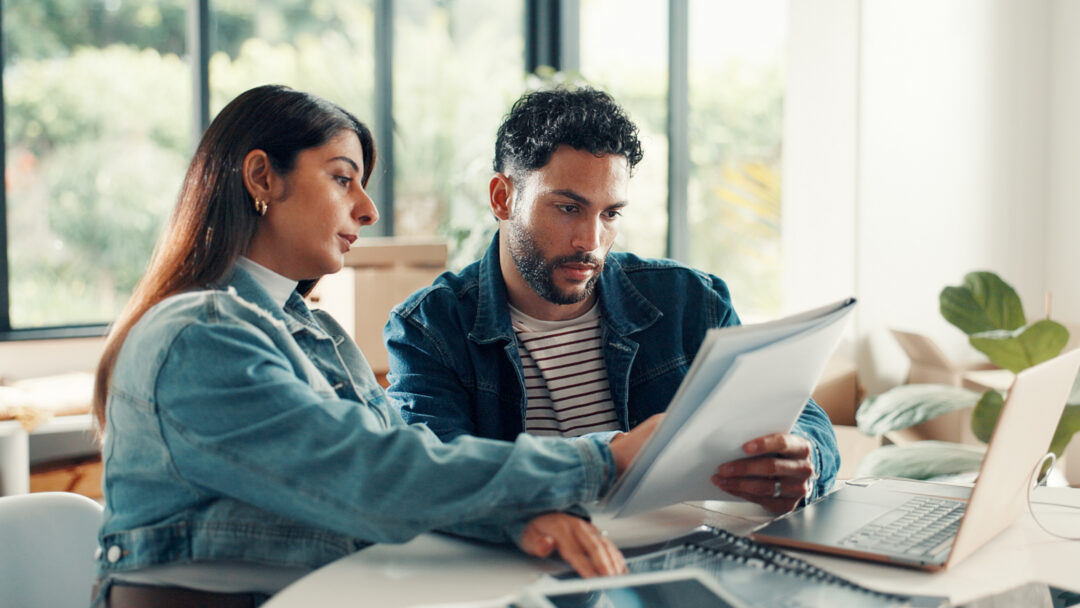 House, documents and couple with laptop, discussion and planning finance with savings. Assets, paperwork and man with woman, pc and expenses with budget, mortgage payment or bills with life insurance