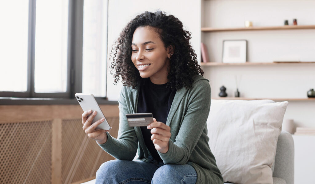 Woman holding credit card and using smartphone at home, businesswoman shopping online, e commerce, internet banking, spending money, working from home concept