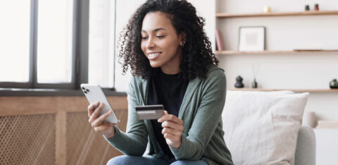 Woman holding credit card and using smartphone at home, businesswoman shopping online, e commerce, internet banking, spending money, working from home concept