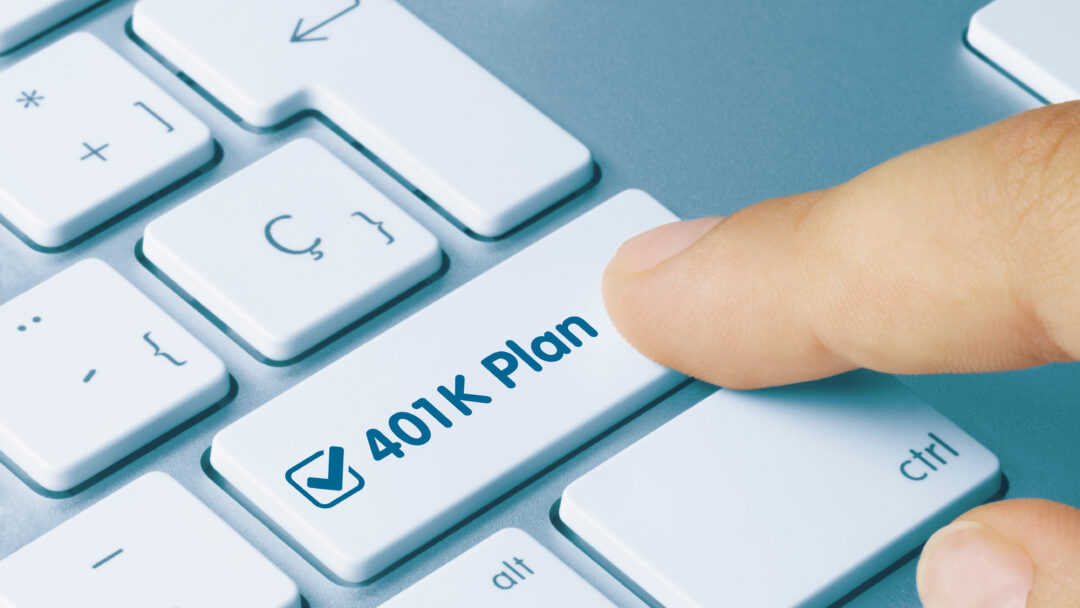 finger pressing a button on a computer that says 401k plan