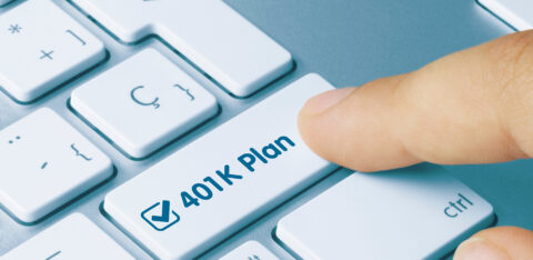 finger pressing a button on a computer that says 401k plan
