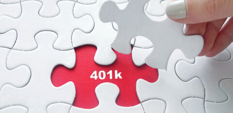 Hand placing jigsaw puzzle with 401k text