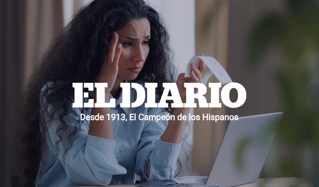 Person reviewing credit card statements and household finances while managing rising debt costs.