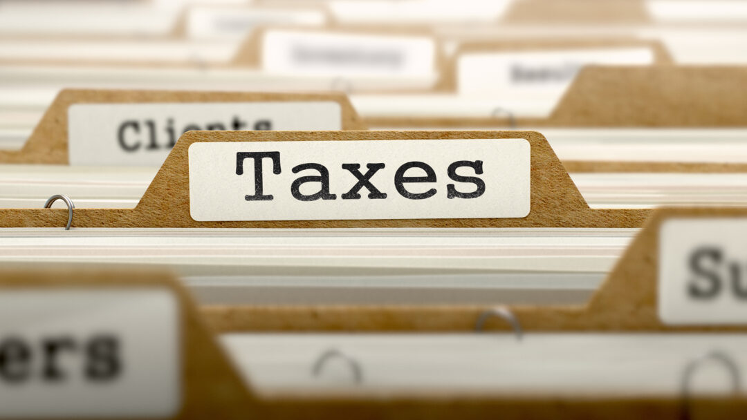 Taxes Concept with Word on Folder.