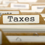 Taxes Concept with Word on Folder.