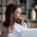 Head shot stressed young woman thinking of financial troubles.