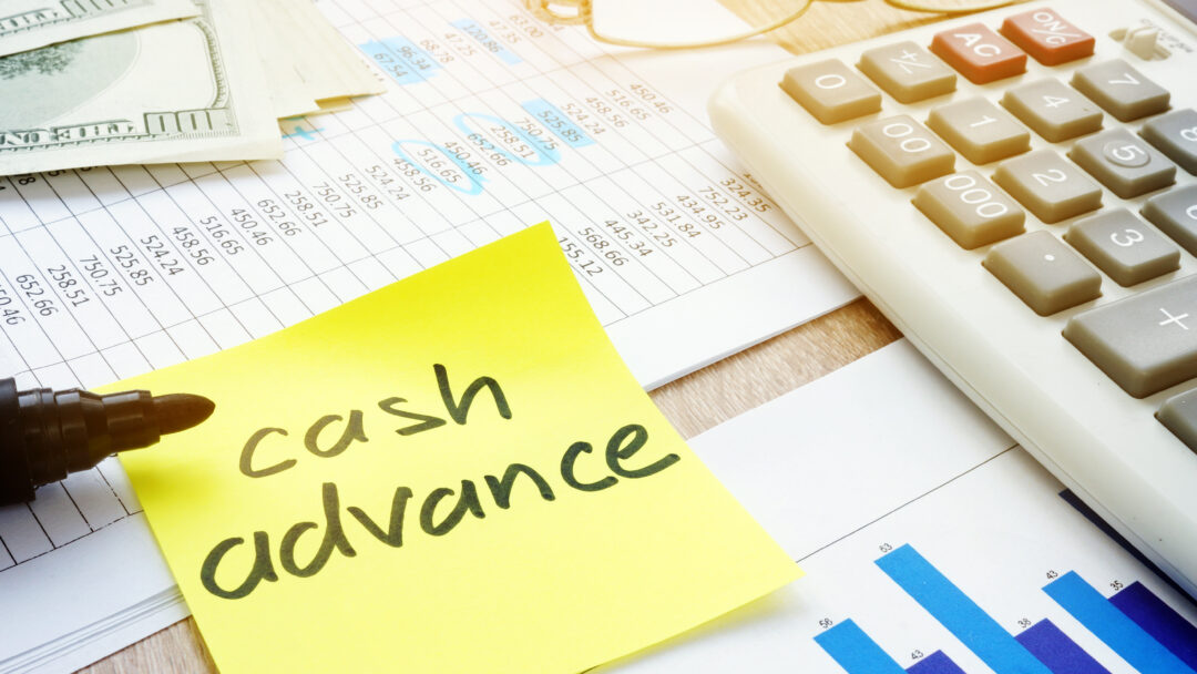 Memo stick about cash advance and calculator.