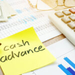Memo stick about cash advance and calculator.