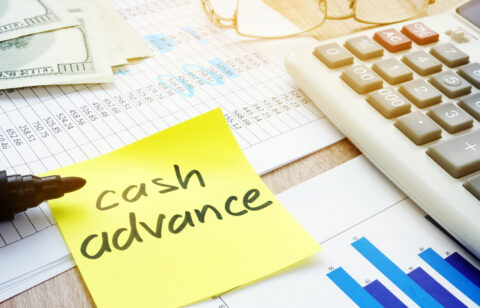 Memo stick about cash advance and calculator.