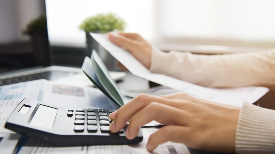 Woman calculating her Debt.