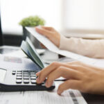 Woman calculating her Debt.