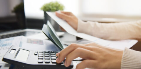 Woman calculating her Debt.