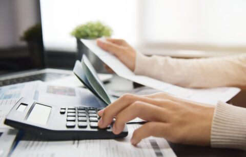 Woman calculating her Debt.