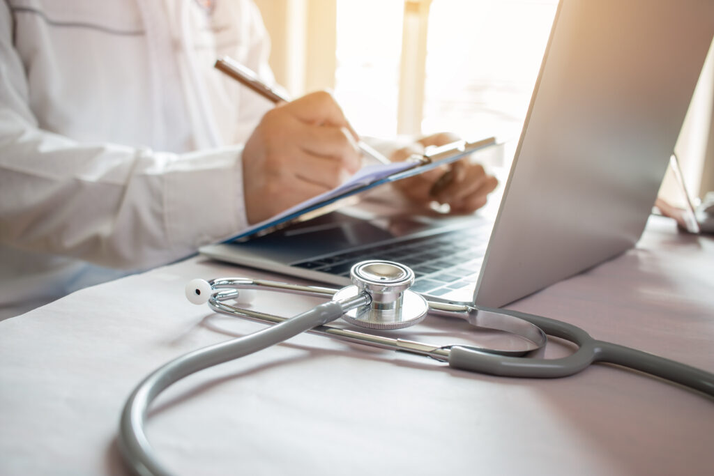Medicine doctor's writing on laptop in medical office.Focus stet