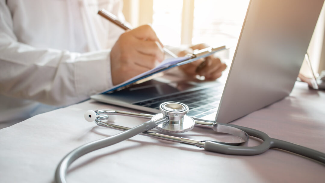 Medicine doctor's writing on laptop in medical office.Focus stet