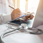 Medicine doctor's writing on laptop in medical office.Focus stet