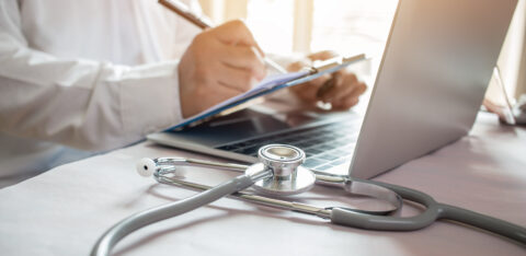 Medicine doctor's writing on laptop in medical office.Focus stet