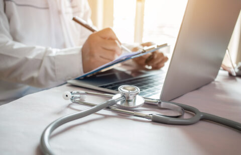 Medicine doctor's writing on laptop in medical office.Focus stet