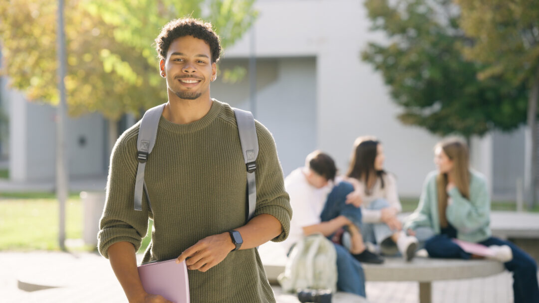 Young student smiling on university campus