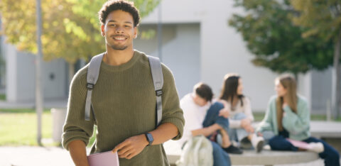 Young student smiling on university campus