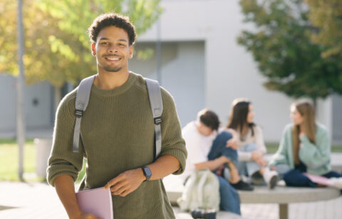 Young student smiling on university campus