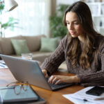 Tele worker working online at home using laptop