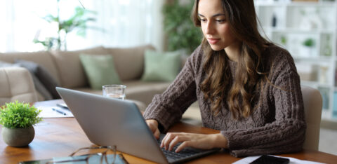 Tele worker working online at home using laptop