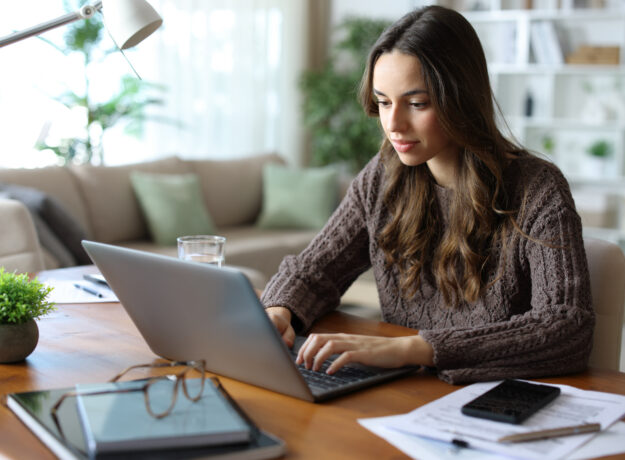 Tele worker working online at home using laptop